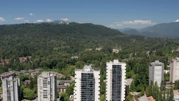 Apartment Complex With Green Forest At Burnaby Mountain In BC, Canada. - aerial