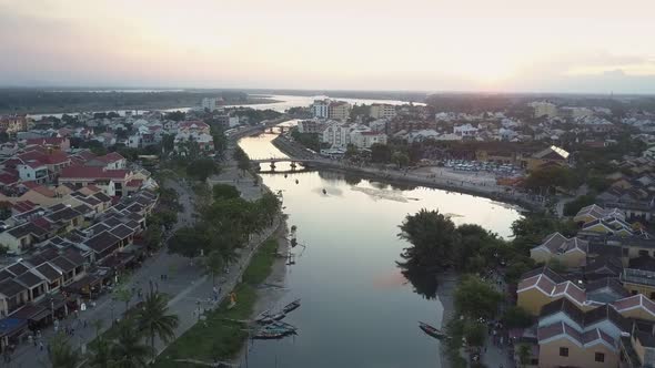 Bird Eye Flight Tranquil River Meanders in Town at Sunset