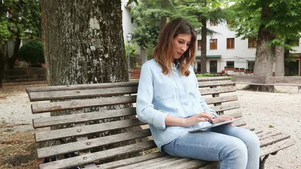 Young Woman Using Digital Tablet Outdoor