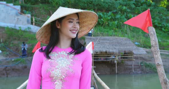 Girl In National Costume Of Vietnam Walking On Bamboo Bridge