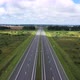 Cars Drive Along Highway with Streetlights Across Meadow - VideoHive Item for Sale