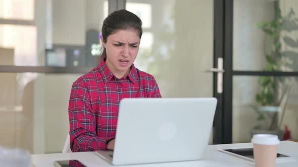 Indian Woman Reacting to Loss While Using Laptop