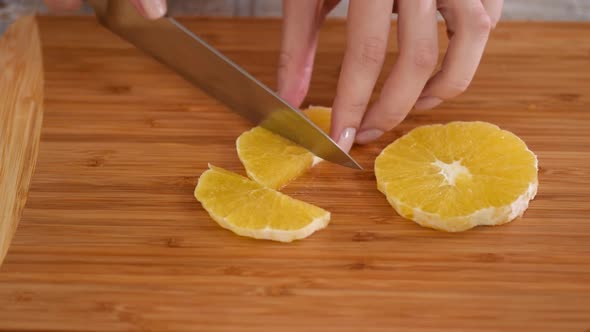 Closeup of Cut Orange Fruit on Wooden Cutting Board