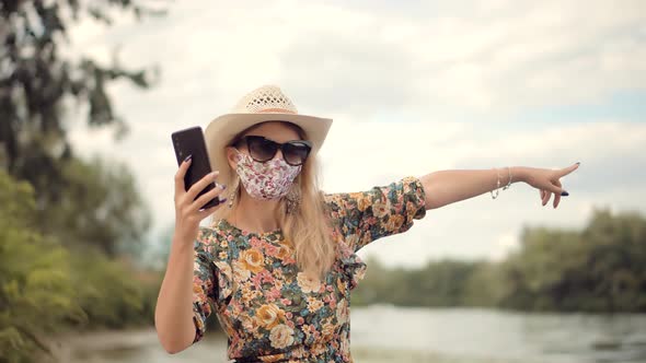 Girl Walking In Face Mask Talking On Phone COVID19 Virus. Safety Pandemic Protection Concept.