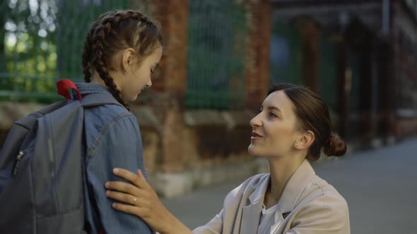 Mother Gives Advices to Her Schoolchild on the Street Before School Time