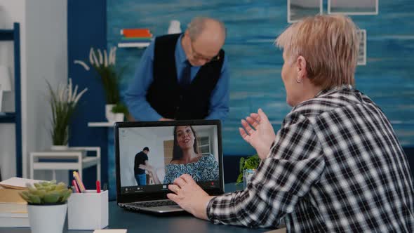 Middle Aged Woman Talking Video Conference with Children