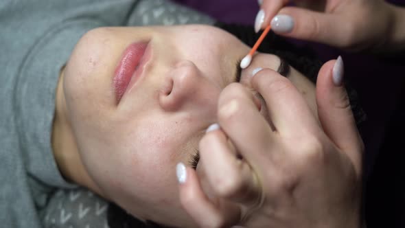 A Young Woman Undergoes an Eyelash Extension Procedure and Removes Mascara with a Cotton Swab and