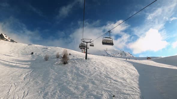 FPV POV of Cable Chair Ski Lift Ascend for Alpine Skiing in Dolomites Italy