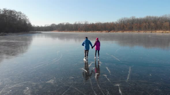 Happy Couple Ice Skating Outdoors on a Frozen Lake on a Lovely Sunny Winter Day, Ice Skating Lovely