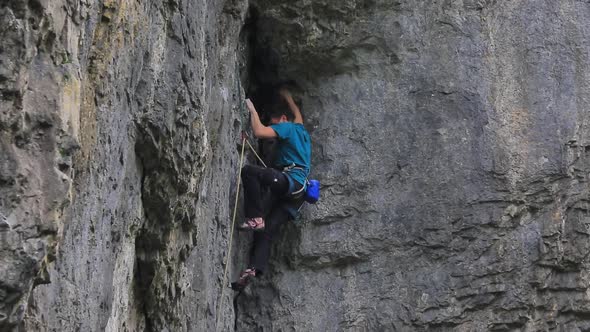 A man rock climbing up a mountain.