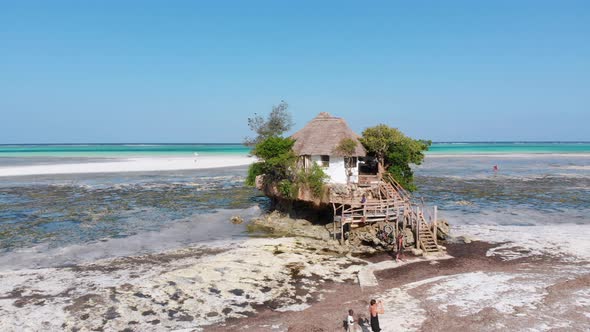 The Rock Restaurant in Ocean Built on Cliff at Low Tide on Zanzibar Aerial View