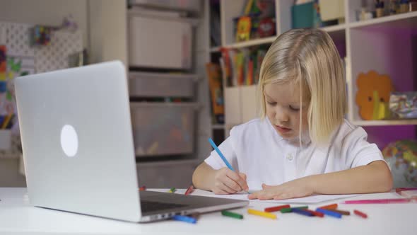 Distance Learning Online Education. A Cute Preschool Boy Learning at Home