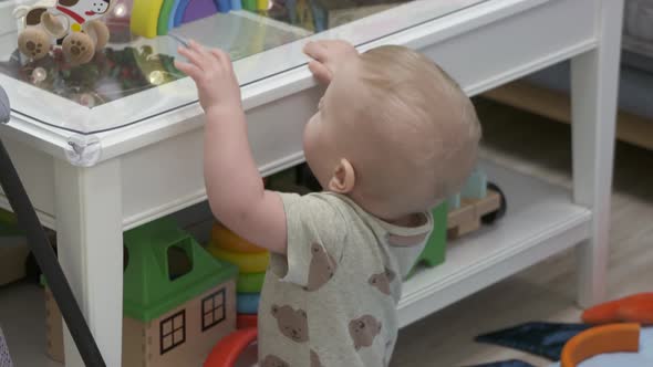 Cute Small Child Playing with Wooden Toys 10 Month Old Baby Boy Holding Rainbow Stacker Blocks