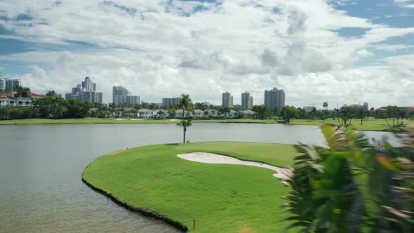  Cinematic Aerial View of Green Golf Course at the Scenic Lake, Miami