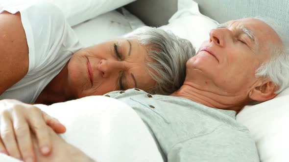 Senior couple sleeping in the bedroom