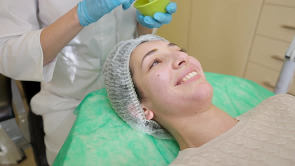 Young Woman Receiving Fruit Acid Peeling in Beauty Clinic