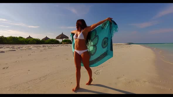 Girl sunbathing on tranquil sea view beach adventure by blue green ocean with white sandy background