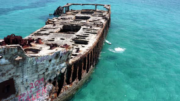 Drone Aerial View, Female Person Jumping From Shipwreck in Turquoise Sea Water. SS Sapona Wreck, Bim