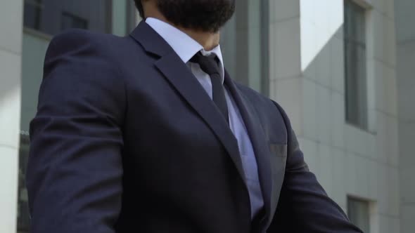 Successful Afro-American Businessman Standing Near Office Building, Closeup