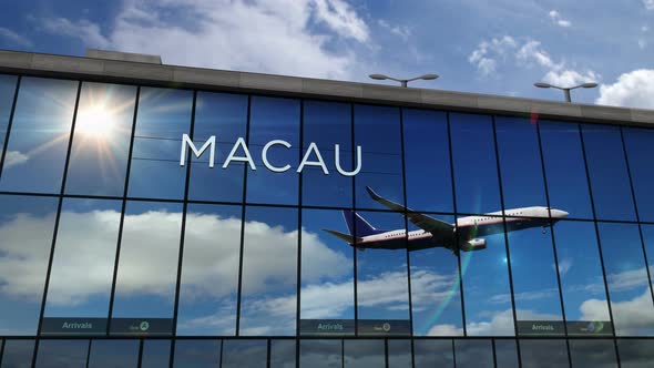 Airplane landing at Macau China airport mirrored in terminal