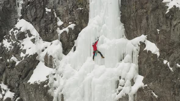 Climber climbing up vertical cascade Maineline, Kineo