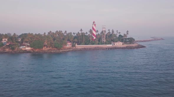 Thangassery Lighthouse on Indian Ocean coast in India. Aerial drone view