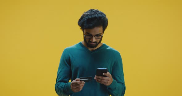 Young Man Paying on Internet