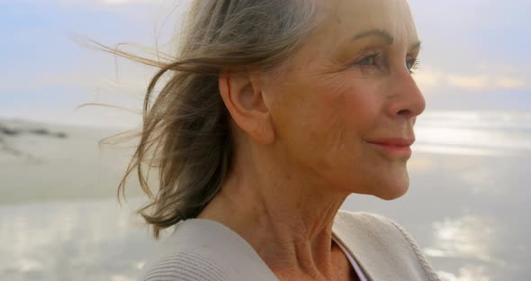 Active senior Caucasian woman standing on the beach 4k