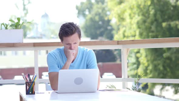 Coughing Young Man at Work, Sitting Outdoor