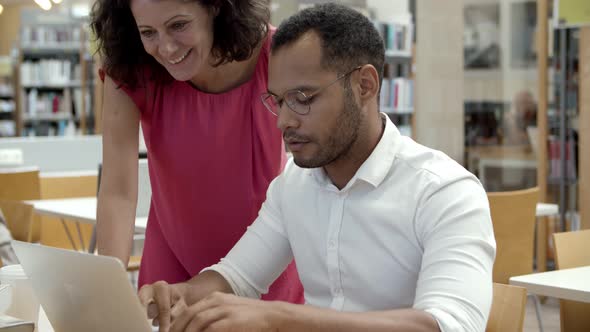 Smiling Young People Communicating at Library