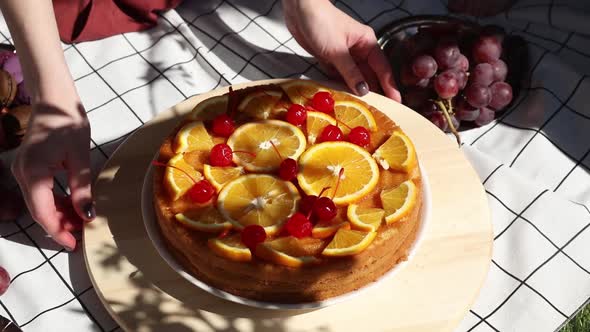 pie with oranges for a event day on picnic checked cloth