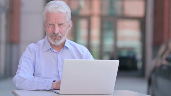 Outdoor Old Man Saying No with Finger Sign