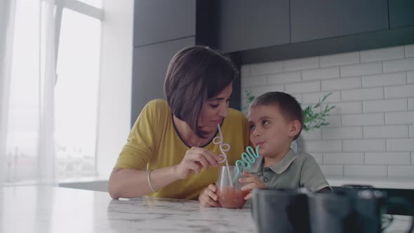 Mother and Son Drink the Juice of the Tubes