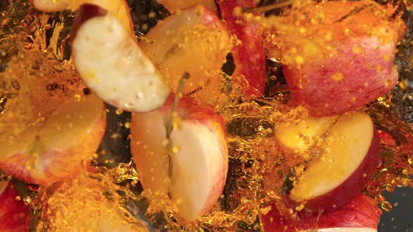 Super Slow Motion Shot of Red Apple Cuts Falling and Splashing Into Juice at 1000Fps alt