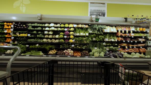 Moving Shopping Trolley in Supermarket Purchase of Vegetables and Fruits