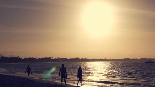 Unrecognizable Couple Walking Along the Beach