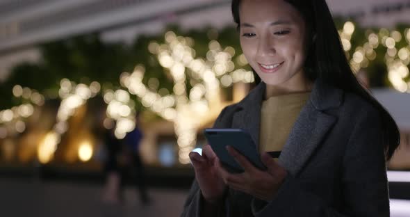 Business woman use of mobile phone at night