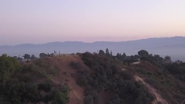 AERIAL: Over Hollywood Hills at Sunrise with View on Hills and the Valley in Los Angeles View 