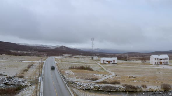 Car Driving On The Road To Dovre Mountains (Dovrefjell) In South-central Norway On A Cloudy Winter D