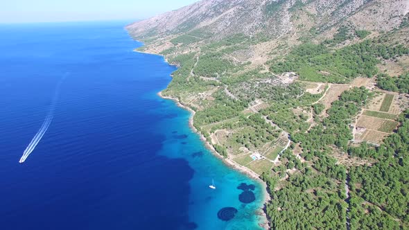 Aerial view of a boat passing sandy beach on the island of Brac, Croatia