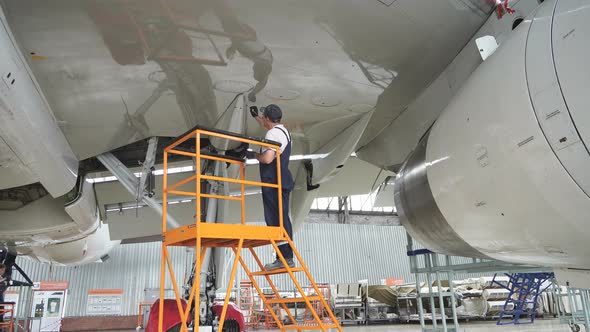 Maintenance of Passenger Aircraft. Repair of an Airplane Wing.  Passenger Plane in the Hangar