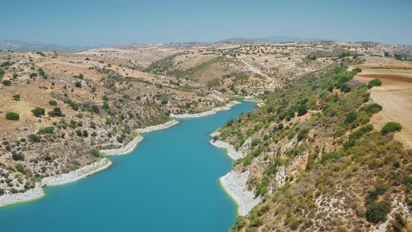 Aerial Reservoir Dam View of Blue River or Lake in Mount Valley Desert Area in Cyprus