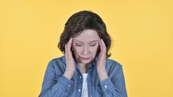 Old Woman Having Headache on Yellow Background 