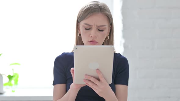 Portrait of Woman Having Loss on Tablet in Office