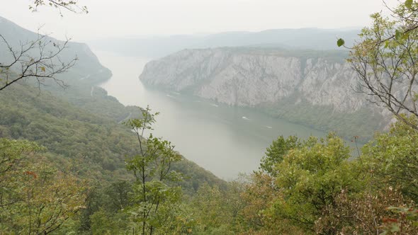Beautiful Danube gorge on foggy day 4K 2160p 30fps UltraHD footage - Narrowest point of big river fl