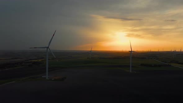 Eco turbines in the field. Windmills at sunset