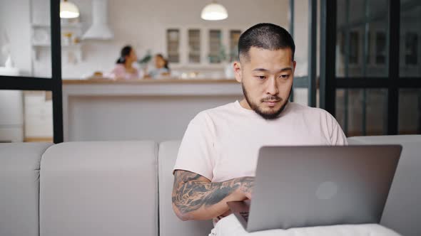 Busy Father Works on Grey Laptop Typing Important Article