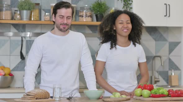 Mixed Race Couple Showing Yes Sign in Kitchen Head Shake