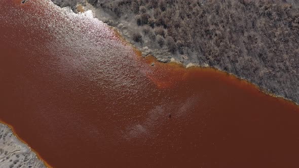 Over the polluted red  mining drainage water 4K aerial video