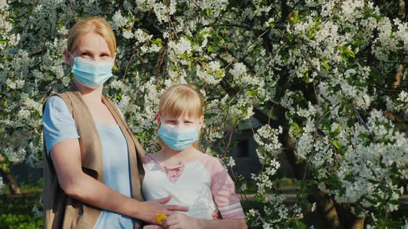 Two Men Who are Allergic to Masks Against the Background of a Flowering Tree